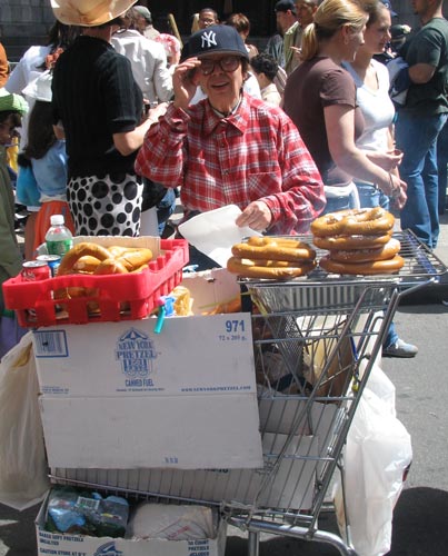 A unathorized pretzel vender with her shopping cart-grill. True NY.