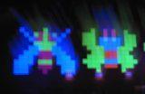 Galaga video game motif made with neon paper.