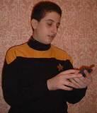 Trek Commander Joshua - Lunacon Ops Officer, Commander Joshua Goldberg, scans the masquerade crowd for anomolies with his Palm-3 Tricorder at NY's 2001 Lunacon Sci-Fi Convention. Homemade Trek costume featuring thumbtacks as rank 'pips' constructed by ...