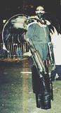 Black Angel of Death - Ominous costume made with wood and mirrored wings along with semi-functional flamethrower hands.  2000 NYC Halloween Parade.